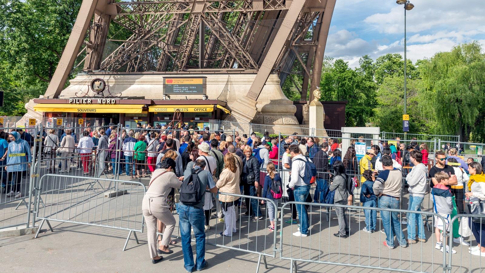 Tourists in queue for tickets to the Eiffel Tower in Paris