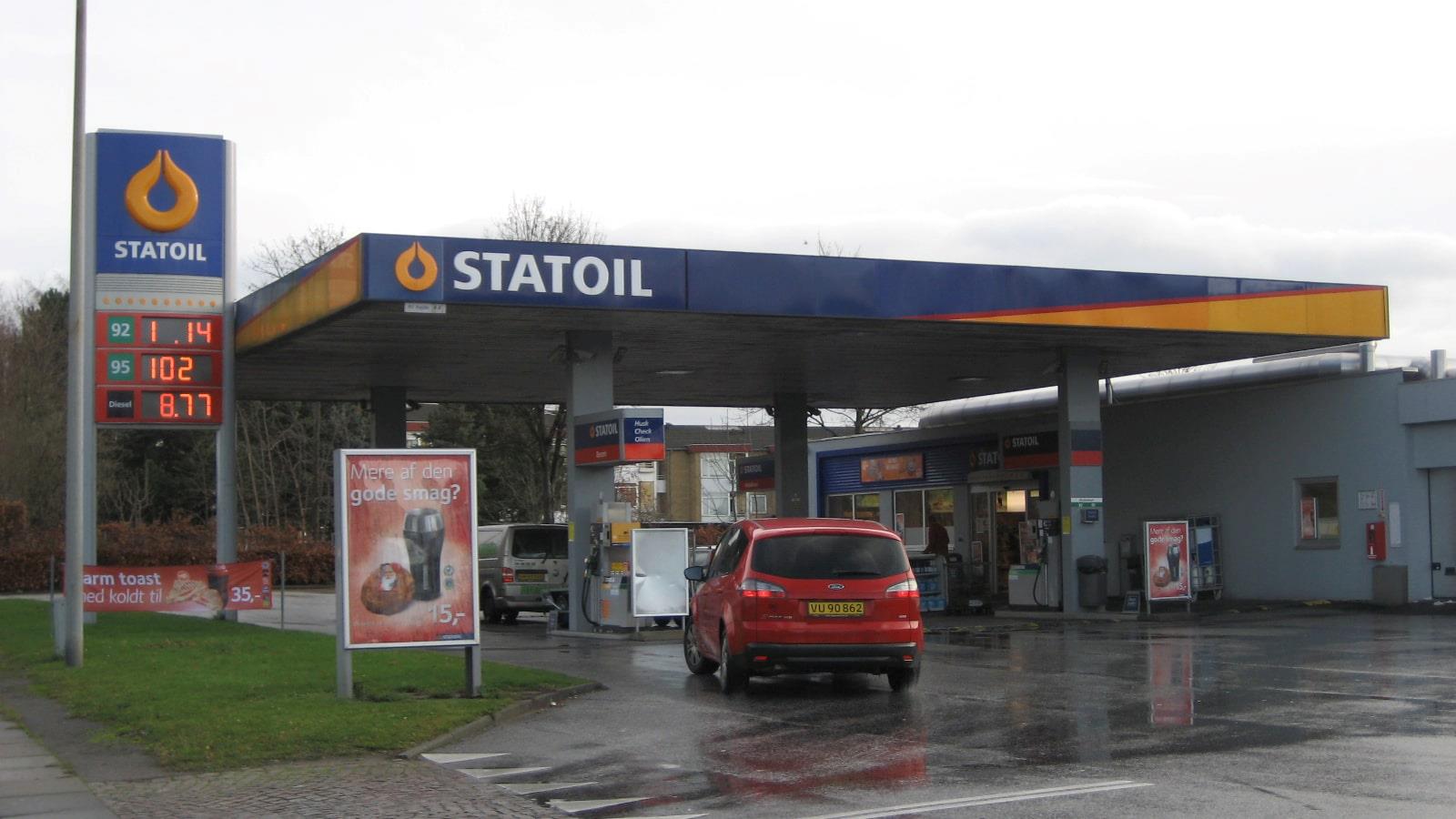Red yellow-plated car drives into Statoil petrol station